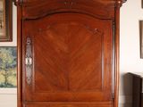a large wooden cabinet in the corner of a room