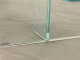 a glass table with a vase on top of it