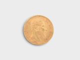 a close up of a gold coin on a white surface
