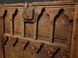 an old wooden bed with a wooden head board