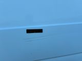 a close up of a white van with a black sticker on it