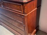 a wooden chest with a marble top in a room