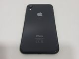 a close up of a black iphone on a white table