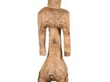 a wooden statue of a man with a hat on his head