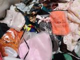 a large pile of clothes that is sitting on the floor