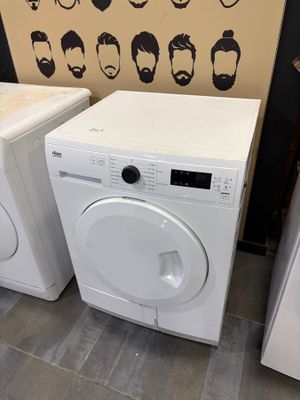 two washers and a dryer in a room