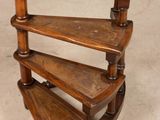 a wooden shelf that has three shelves on top of it