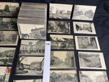 a lot of old black and white photos on the table