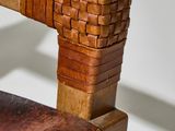 a close up of a wooden chair with a woven seat