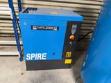 a close up of a blue compressor sitting next to a blue container