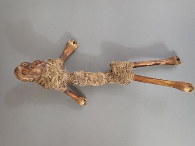 a sculpture of a man made out of wood on a table