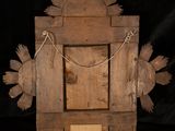 a wooden object with a sun design on it