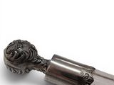 a silver spoon with a lion head on it