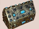 a silver box with blue stones inside of it