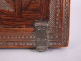 a small wooden box with a metal latch on it