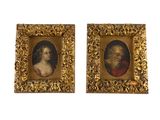 deux portraits encadrés représentant un homme et une femme, dans un cadre doré