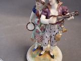 two figurines that are sitting on top of a table