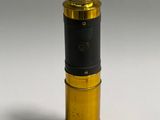 an image of a small gold and black object on a white surface