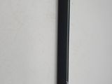a black pen that is on the wall next to a white wall