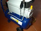 an air compressor sitting on top of a blue and white cart