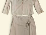 a picture of a woman ' s suit and skirt on a white background