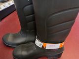 pair of black rubber boots sitting on top of a red table
