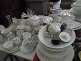 a lot of dishes and cups on a table