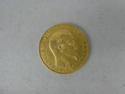 a close up of a gold coin on a white surface