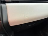 a close up of a car door handle with a hole in it
