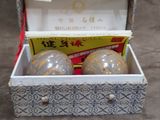 a box with three eggs in it sitting on the floor