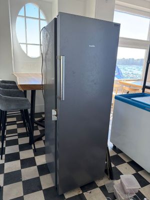 a black and white checkered floor in a kitchen with a refrigerator
