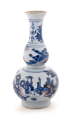 a blue and white vase sitting on a white surface