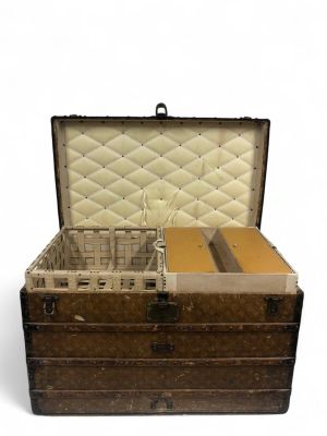 an old trunk with a bunch of items inside of it
