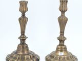 pair of antique brass candlesticks on a white background
