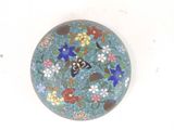 a picture of a blue plate with flowers and butterflies