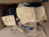 a box full of clothing that is sitting on the floor