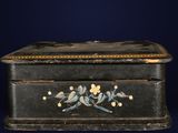 a small black box with birds painted on it