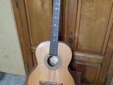 a guitar that is sitting on a wooden stand