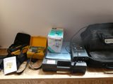 a black bag sitting on top of a shelf next to other items