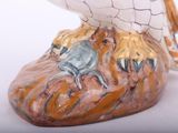 a figurine of an owl sitting on top of a rock