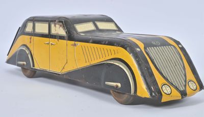 yellow and black toy car sitting on top of a white surface