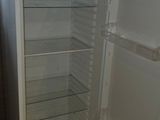 a white refrigerator with its door open in a room