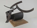 an image of a sculpture made of metal and wood on a wooden base
