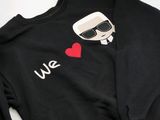 a close up of a black sweatshirt with a red heart on it