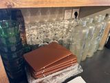 many glass bottles and bottles sitting on a shelf