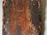 a piece of wood that has been burned and has a tag on it