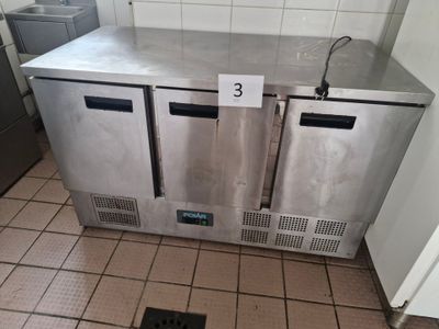 two stainless steel refrigerators in a kitchen with tile flooring