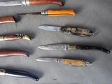 several different types of knives are lined up on a table