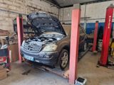 a car that is sitting on a lift in a garage