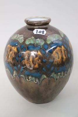 a brown vase with blue and yellow designs on it